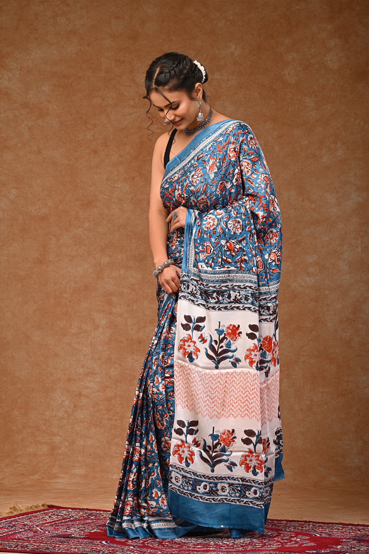 Modal silk saree with attached blouse, adorned with traditional Sanganeri rapid hand block printing.