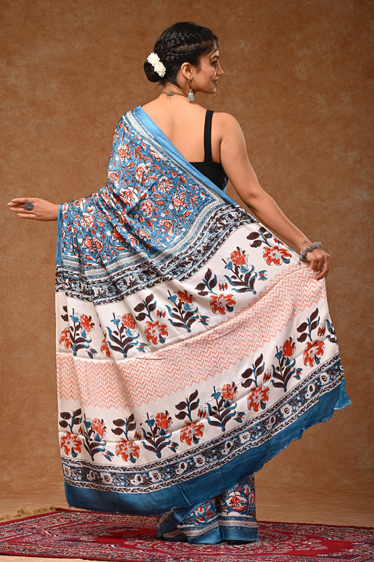 Modal silk saree with attached blouse, adorned with traditional Sanganeri rapid hand block printing.